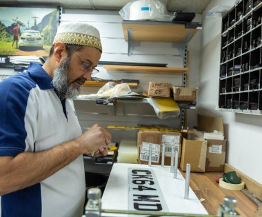 A number plate being created