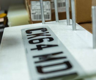 A 4D number plate being created