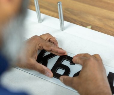 A number plate being created