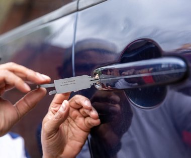 A car being unlocked by a locksmith