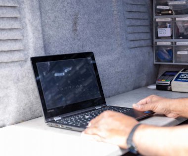 A person typing on a laptop