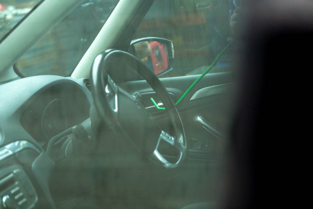 A locksmith unlocking a car