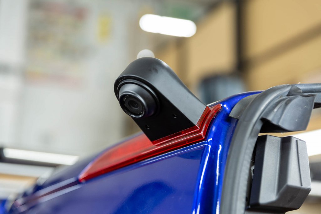 A reversing camera fitted to the rear roof of a blue van
