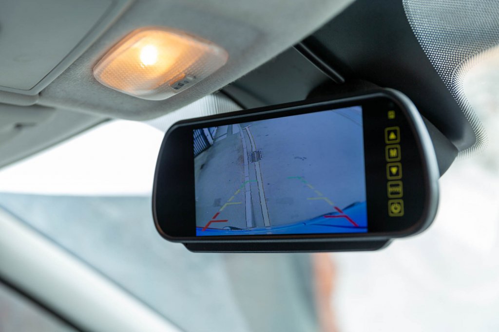 A dash camera display showing the road ahead, fitted in a vehicle