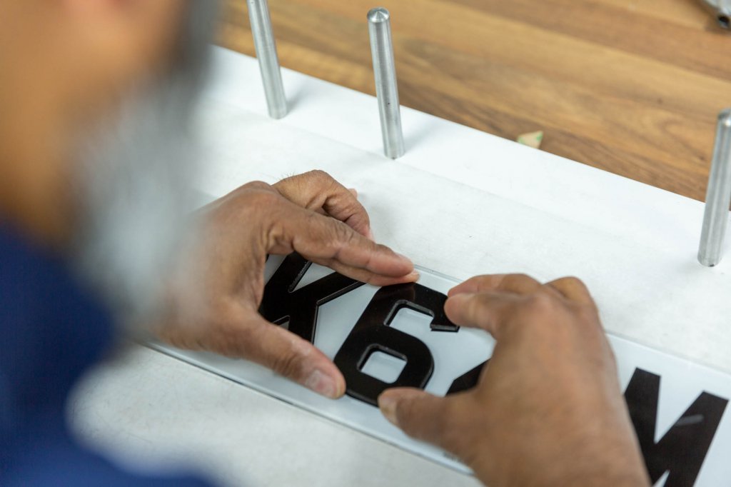 A number plate being created