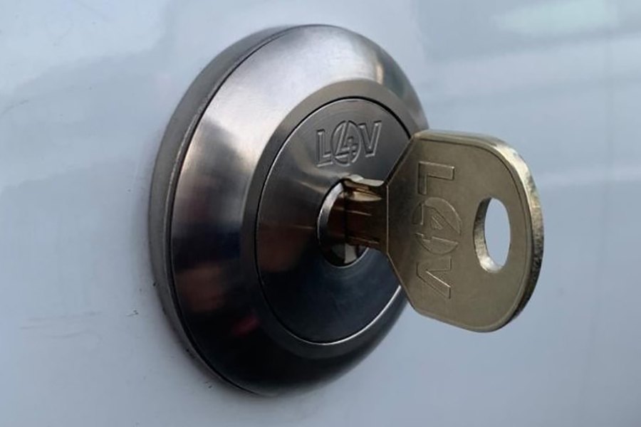A high-security replacement lock and key on a van's driver's door