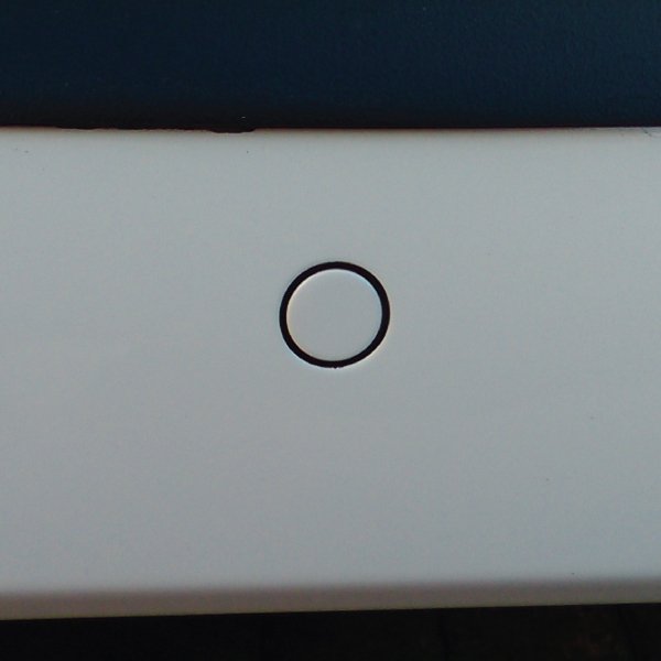 A Steelmate flush-fit parking sensor colour-matched to a white bumper